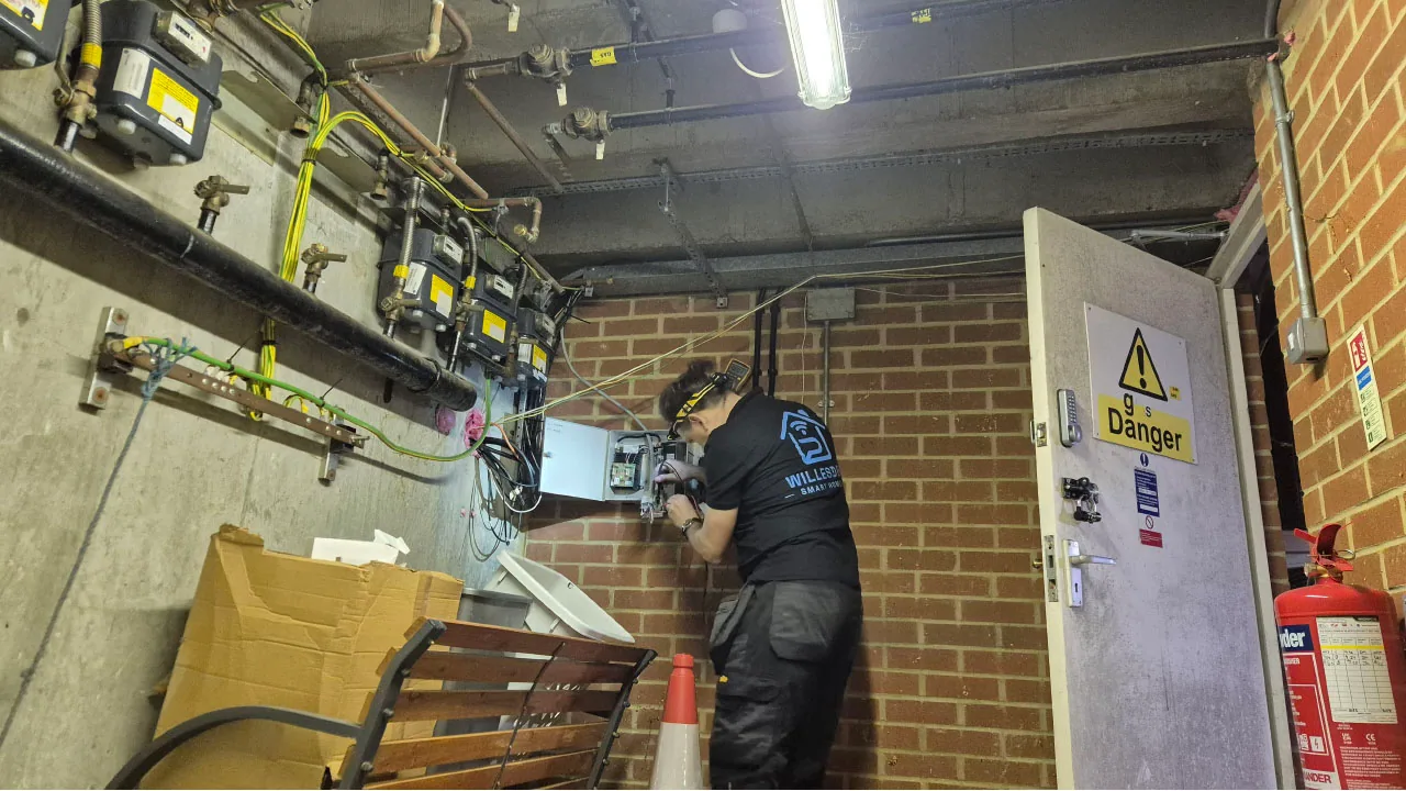 Entry-system control wiring being checked inside a shared building service cupboard.