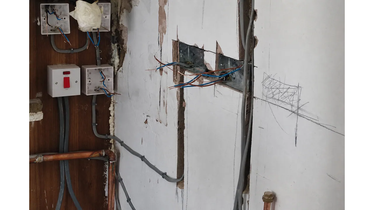 Exposed meter and electrical wiring during a kitchen rewire.