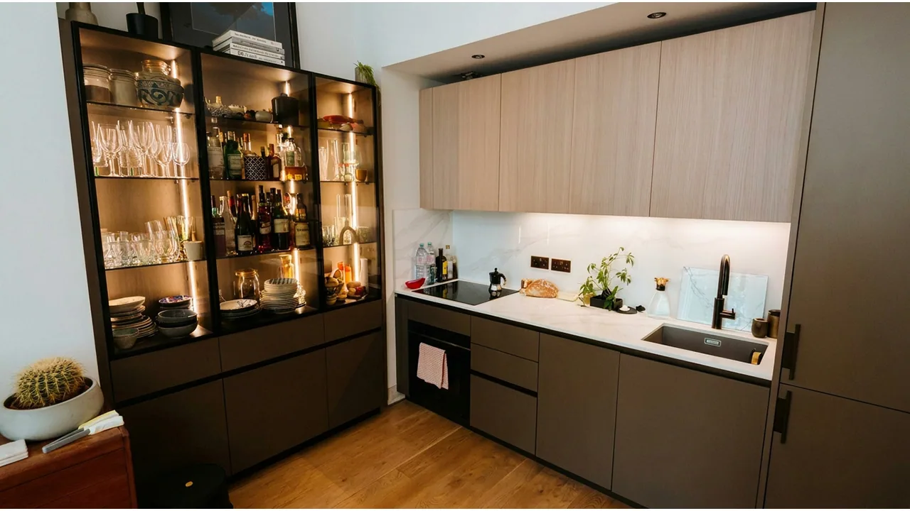 Finished kitchen with under-cabinet lighting, worktop sockets and fitted appliances.