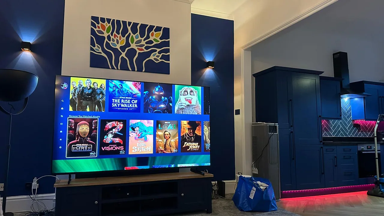 Wall uplighters beside coloured kitchen accent lighting.