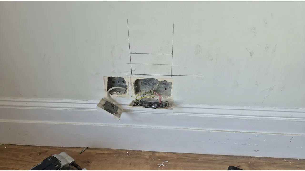 Open socket boxes with faceplates lowered and wiring visible.