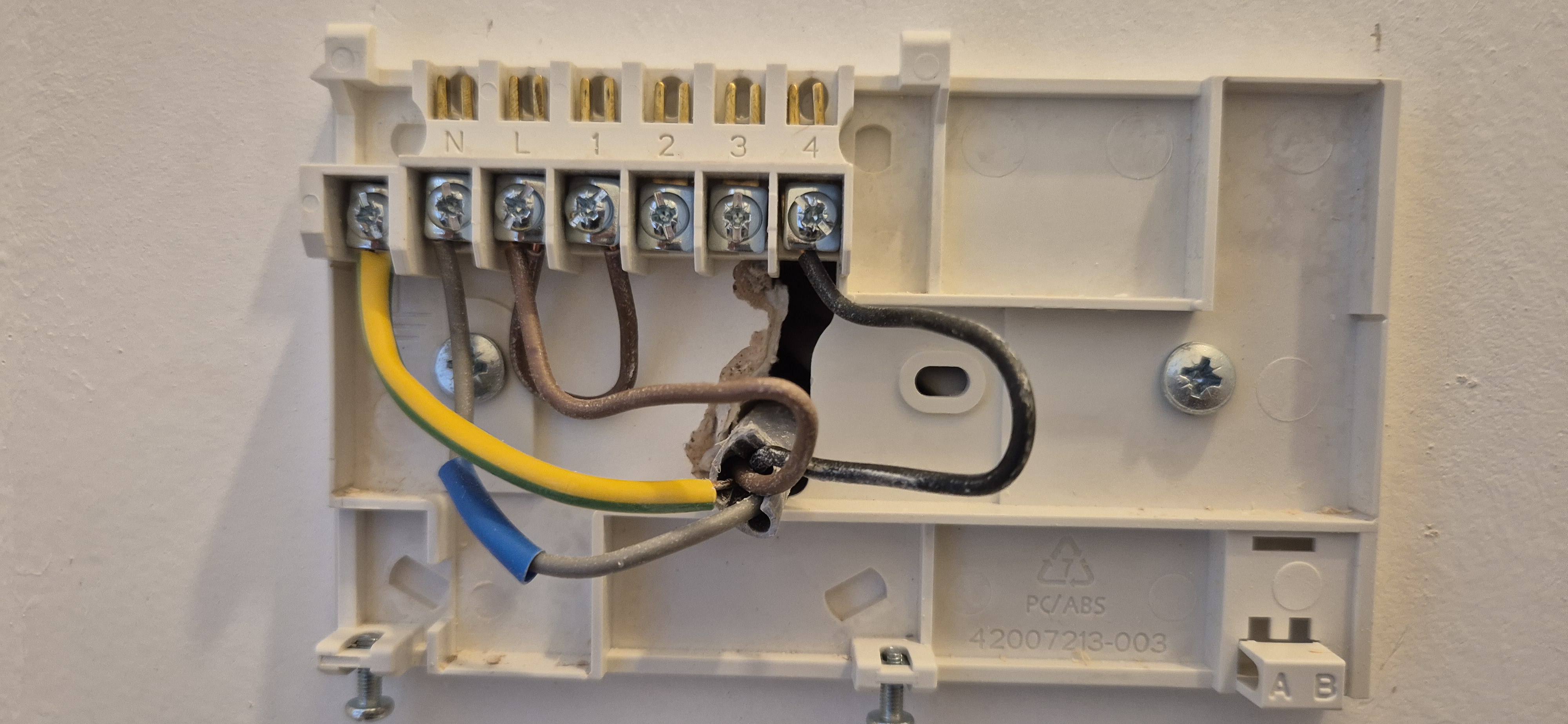 Back‑plate tidied before smart thermostat install – cables neatly dressed